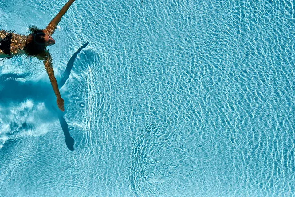 Solepool - Light blue pool, top view with a swimmer swimming into the frame