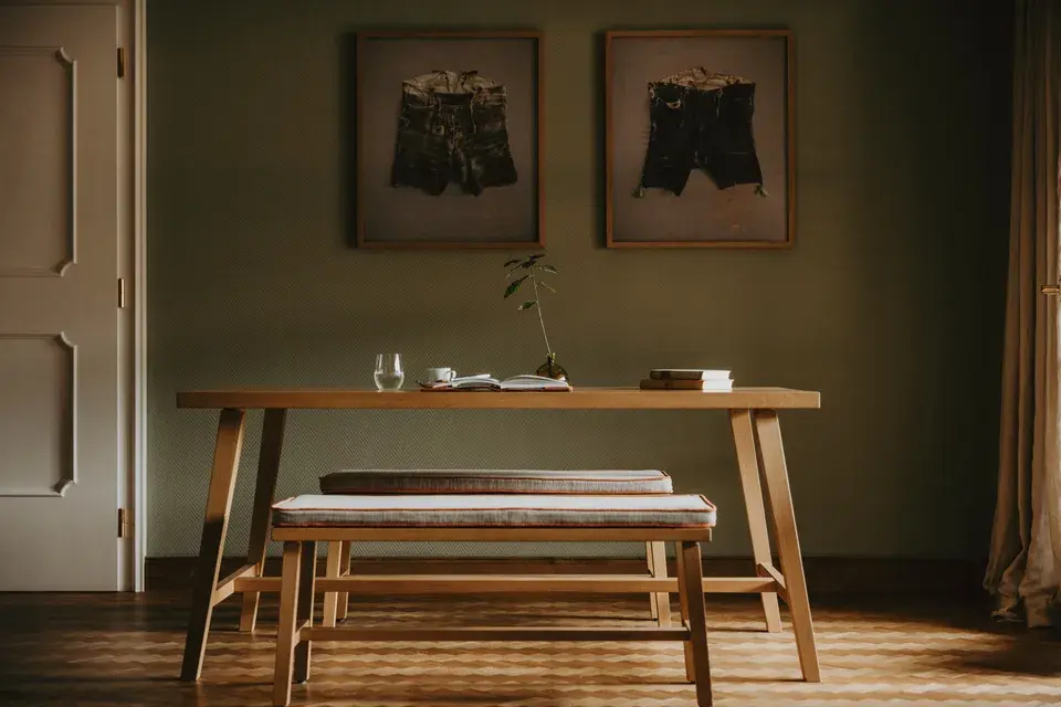 Grand Suite with a wooden dining table and two wooden benches with cushioned seats