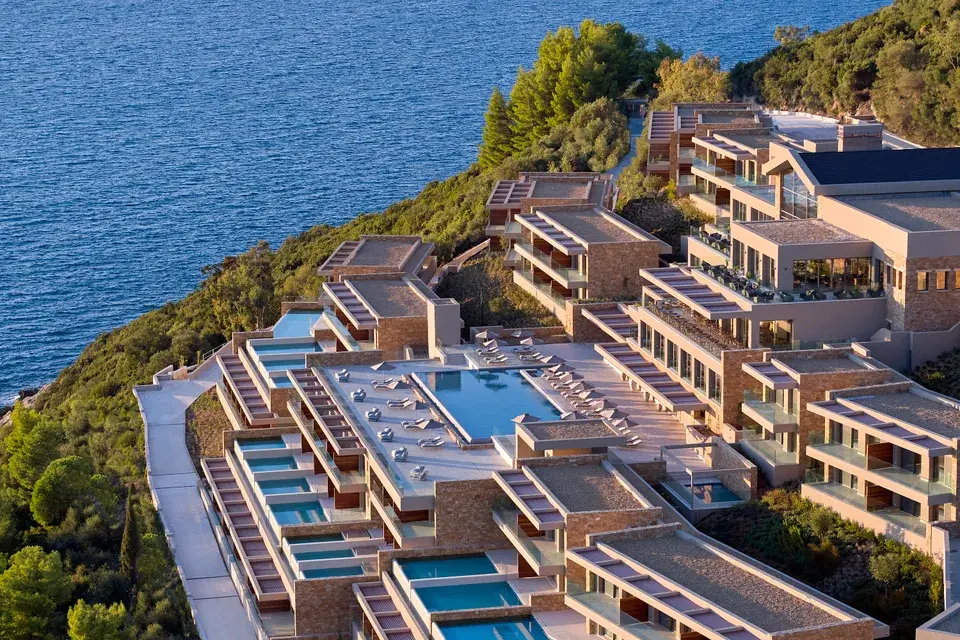 Hillside Elix resort in Epirus with terraced buildings, pools, and views of the Ionian Sea.