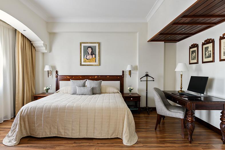 Artemis Suite with a double bed, hardwood floors, and a desk