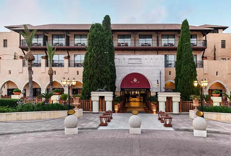 Entrance to the Elysium in Paphos with Mediterranean-style architecture and landscaped grounds